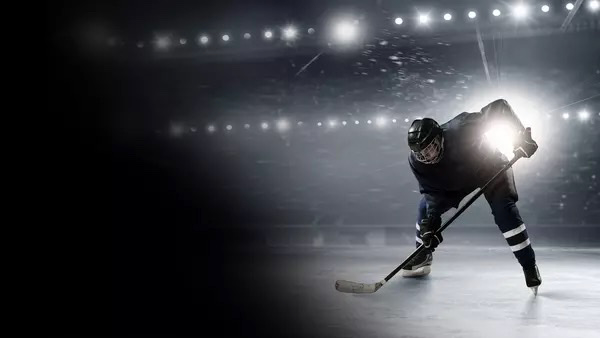 A promotional image for the NHL of a hockey player on ice with a hockey stick.