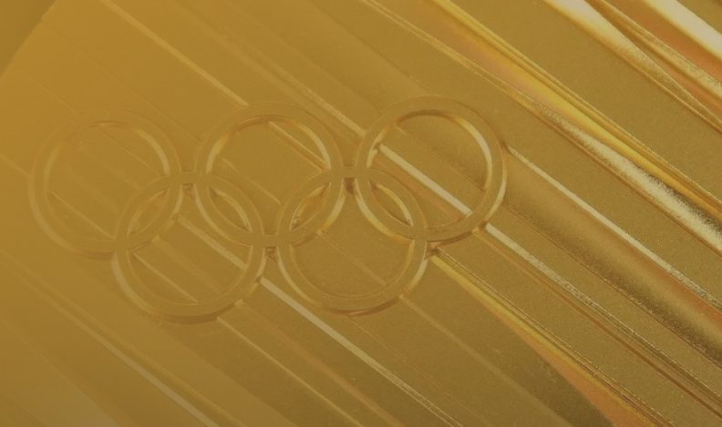 A close-up of an Olympic gold medal representing the 2024 Olympic games.
