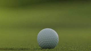 An image of a golf ball on a putting green.