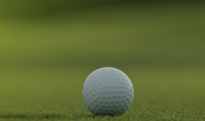 An image of a golf ball on a putting green.