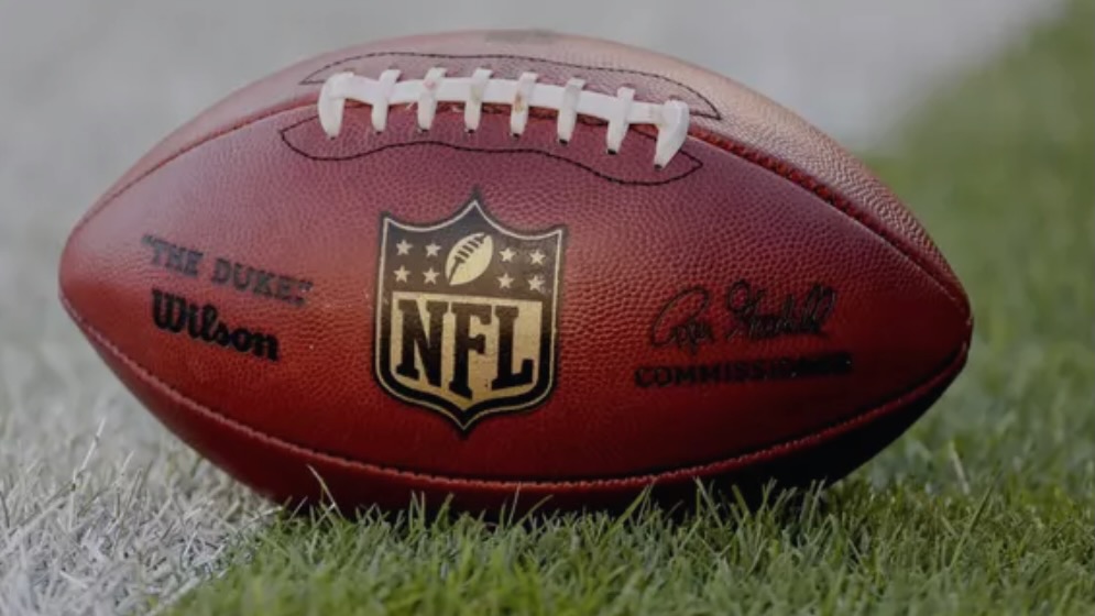 An image of a professional grade football with the official NFL logo on it.